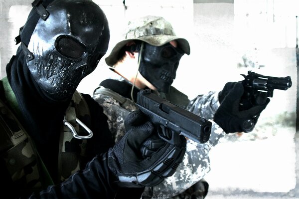 Men in black masks with pistols