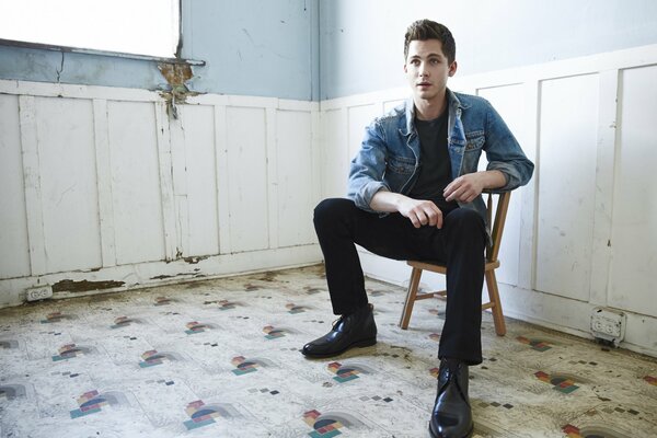Actor Logan Lerman in a room on a chair