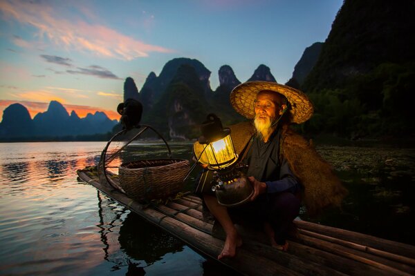 China fisherman on a boat with a lantern