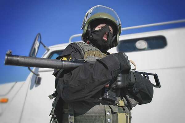 A special forces soldier in a helmet with a machine gun