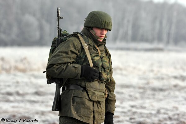 A soldier with a gun stares intently
