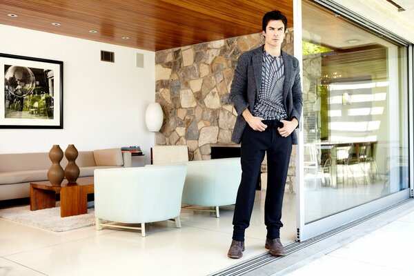 A male actor in a room with an interior