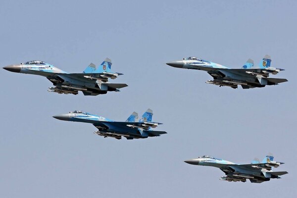 Flight of su-27 aircraft in the clear sky