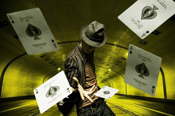 The illusionist in the hat throws away the cards