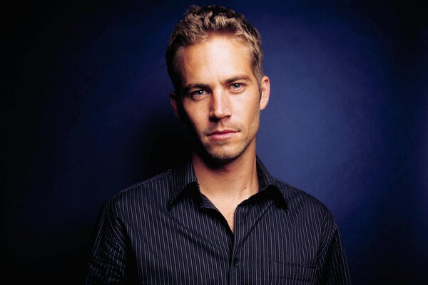 Actor Paul Walker in a shirt on a blue background