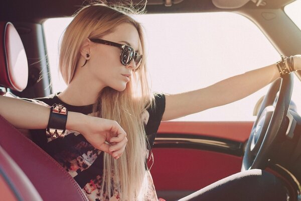 Belle blonde en voiture avec les cheveux longs