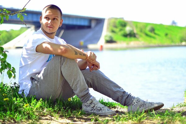 Nikita legostev is sitting on the grass