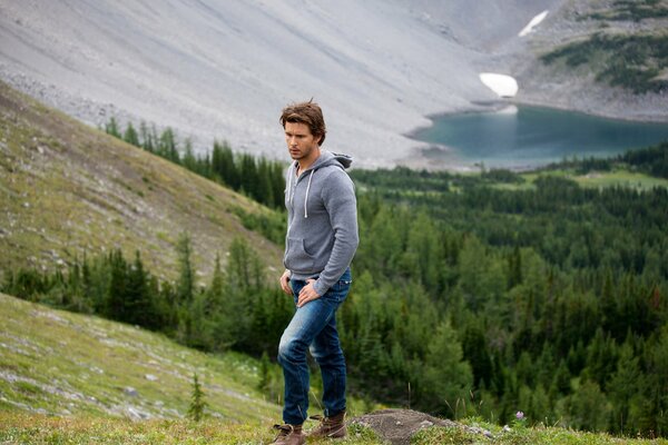 A man in a gray jacket against the background of nature