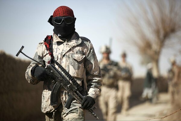 A soldier in camouflage with a gun