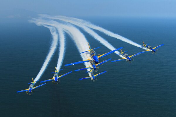 Planes make a beautiful maneuver over the ocean