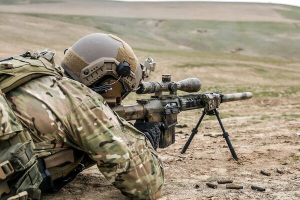 An American sniper shooting with a rifle