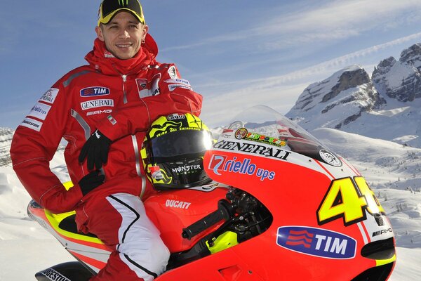 Valentino Rossi on a snowmobile in the mountains