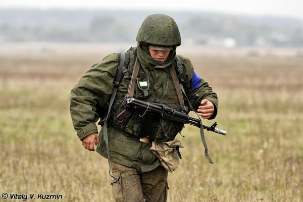 Landing of a paratrooper in a field after a parachute jump