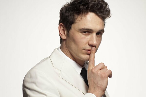 actor James Franco shows the gesture hush 