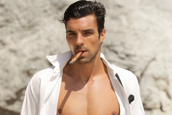 A handsome dark-skinned man with a cigar