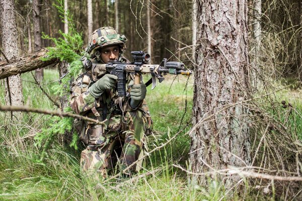 An army soldier in the forest on a mission