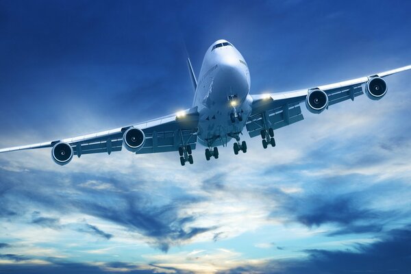 A large plane is flying against the background of clouds