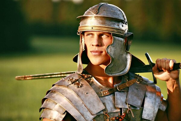 In the field, a Roman in a suit with a sword