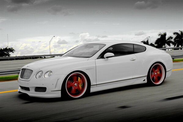 Snow-white Bentley on a summer road