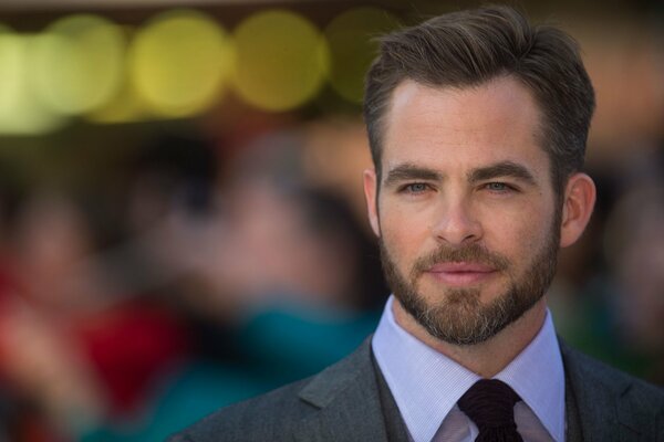 Photo of an actor in a suit with a tie