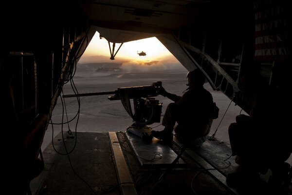 An armed soldier at sunset