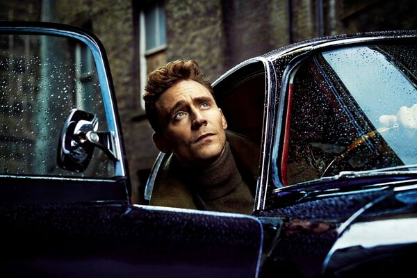 Actor Tom Hiddleston looks out of the car