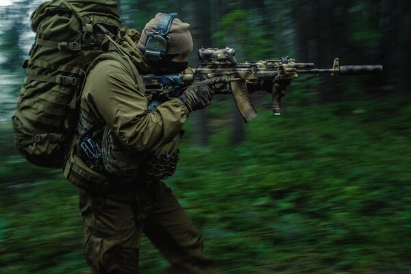 Shooter with a backpack in the woods