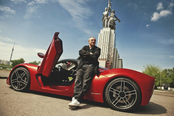 Nikolay Fomenko on the background of a sports car