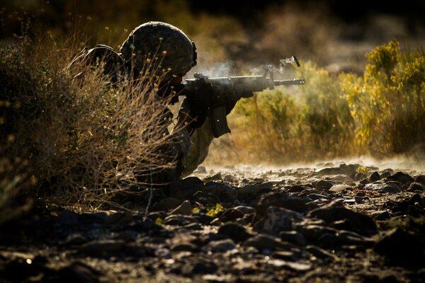 A soldier with a gun in an ambush