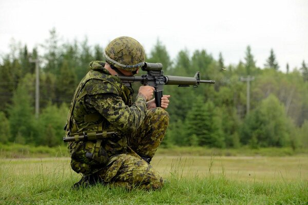 An army soldier shoots at targets