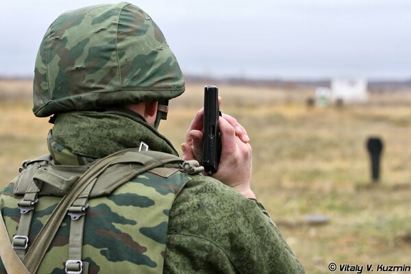 Soldiers in uniform and overalls at the shooting range