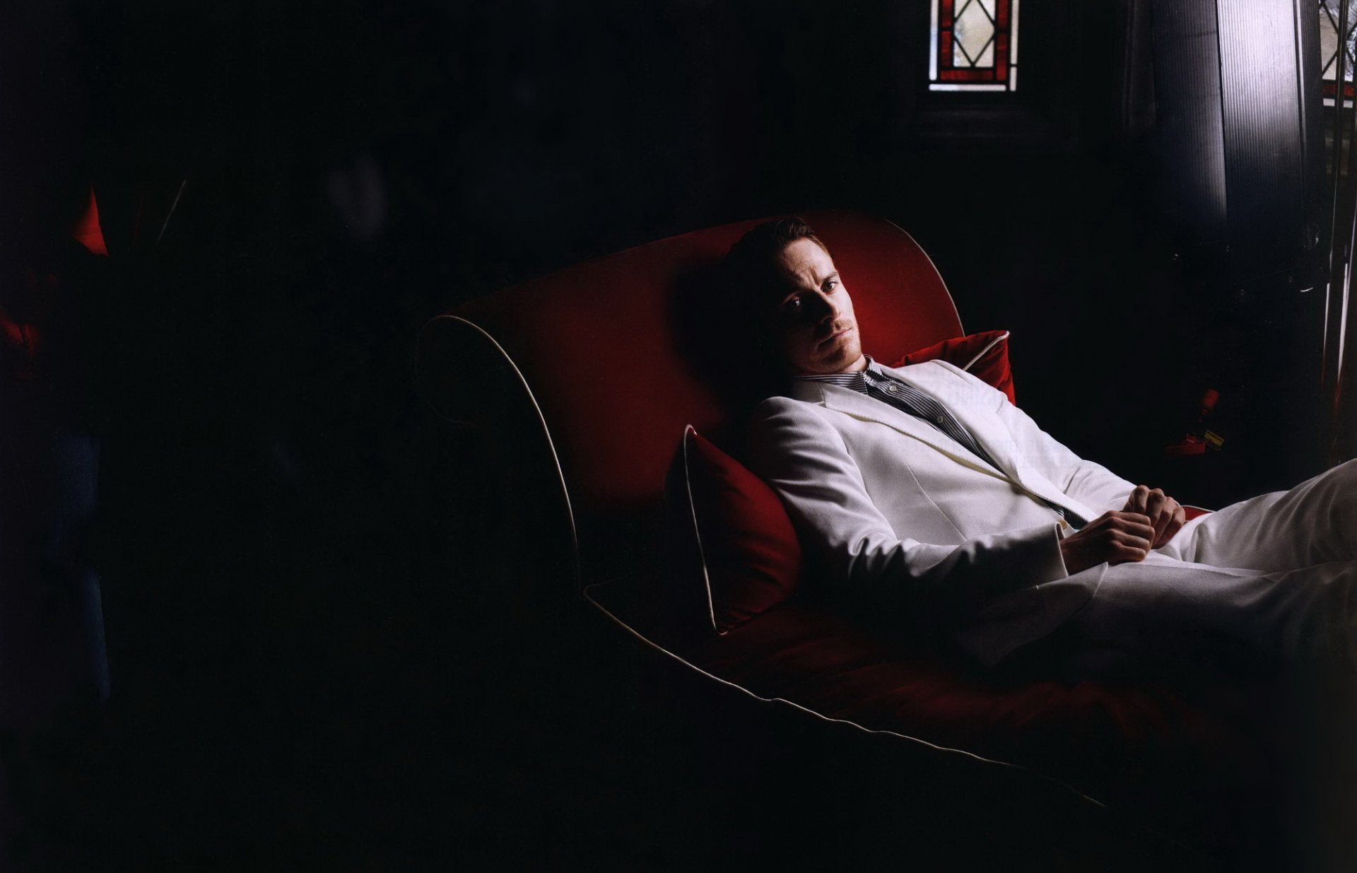 michael fassbender actor red couch white suit