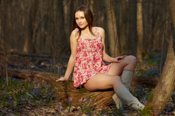 Beautiful girl in a light dress in the forest