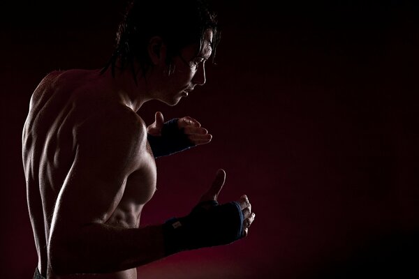 A man is boxing on a red background