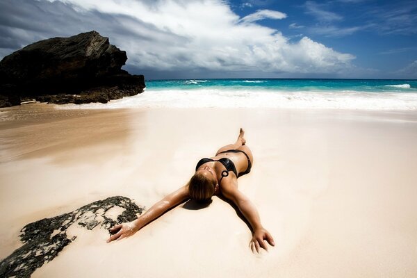 Girl on the beach with golden sand in summer