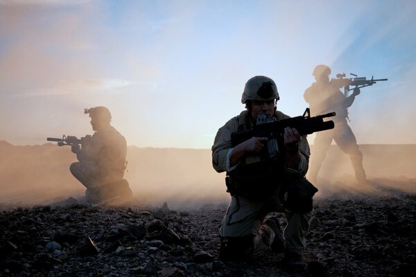 American soldiers in the field with guns