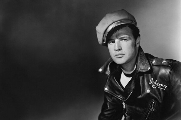 Black and white photo of an actor in a hat