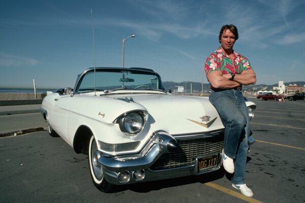 Arnold Schwarzenegger in vintage style near the car