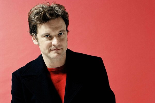 Photo of actor Colin Firth on a red background