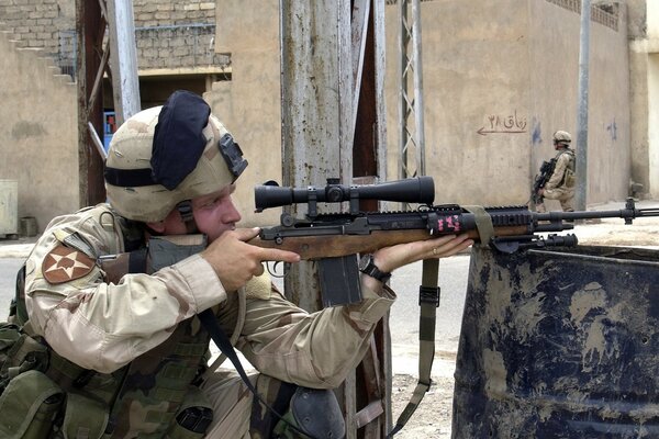 A soldier with a rifle in city blocks