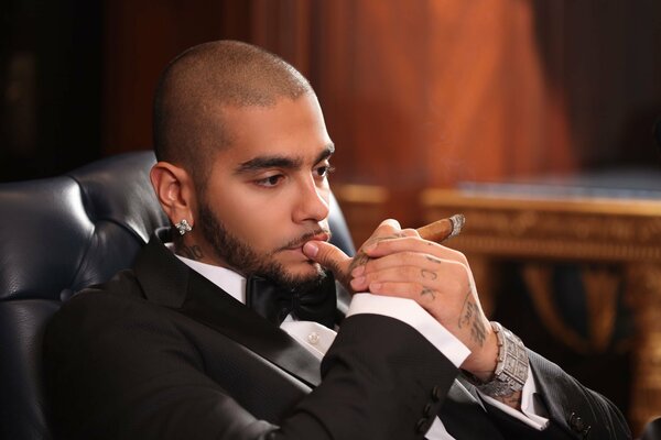 Rapper and Black Star Timati in a suit with a cigar