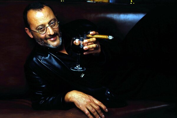 Jean Renaud with a glass of wine and a cigar