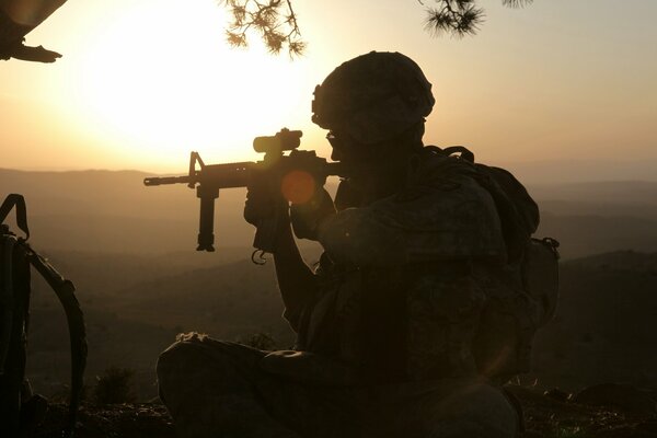 A soldier on the background of sunrise