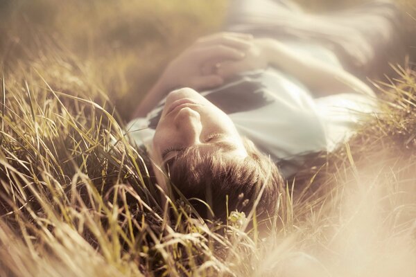 A guy sleeping in a field at dawn