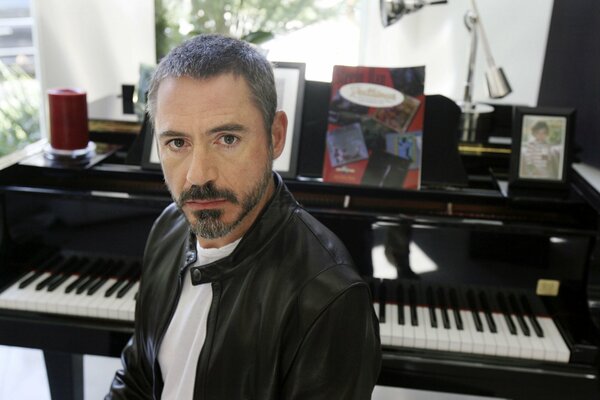 Actor Robert Downey Jr. sits at the piano