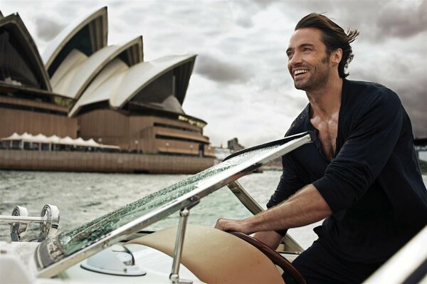 Hugh Jackman eating on a beautiful boat