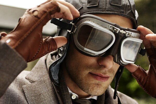 A male pilot puts on glasses