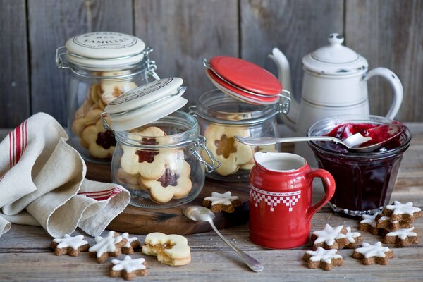 Star cookies on the table in colorful jars