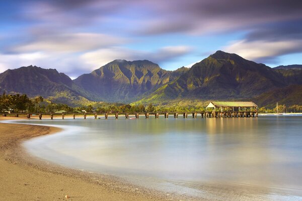 Mountains are reflected in the morning lake