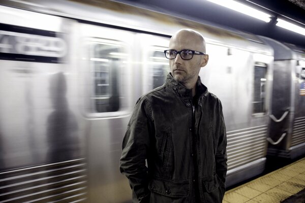 A man on the background of a departing train